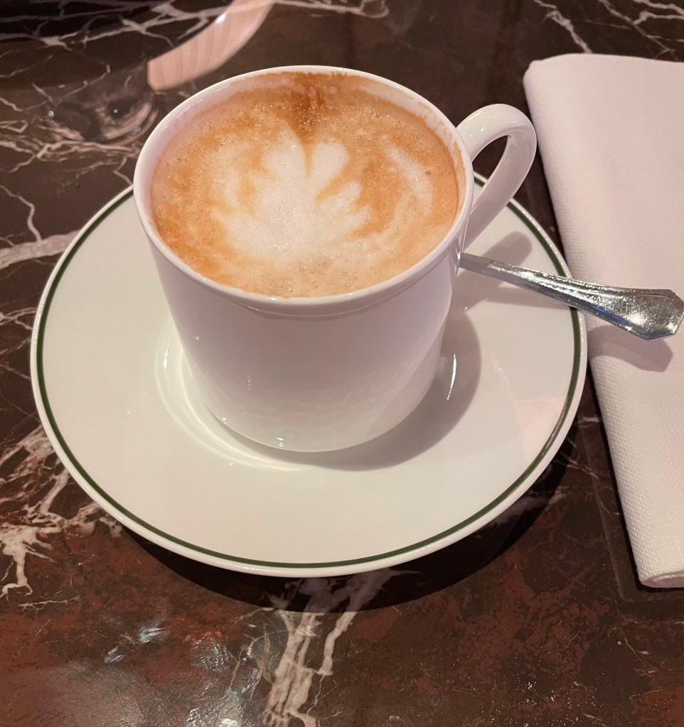 cappuccino in a posh cup on a marble table