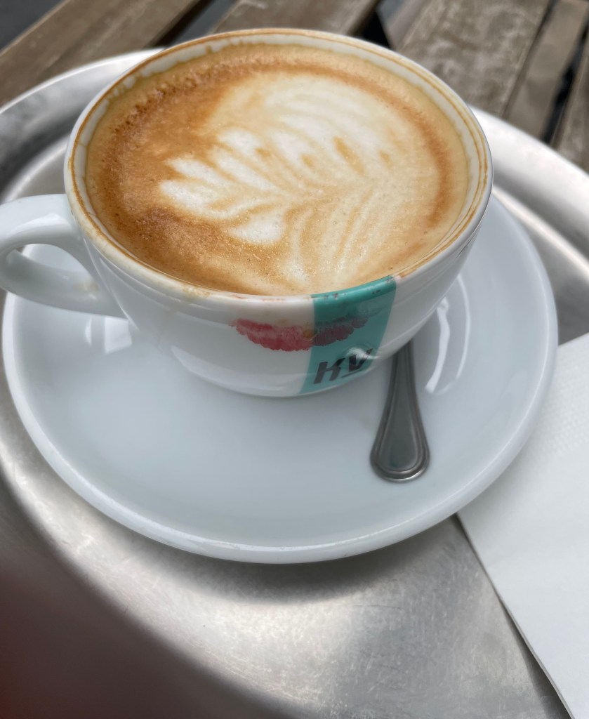 Cappuccino cup with a red lipstick  mark on it.
