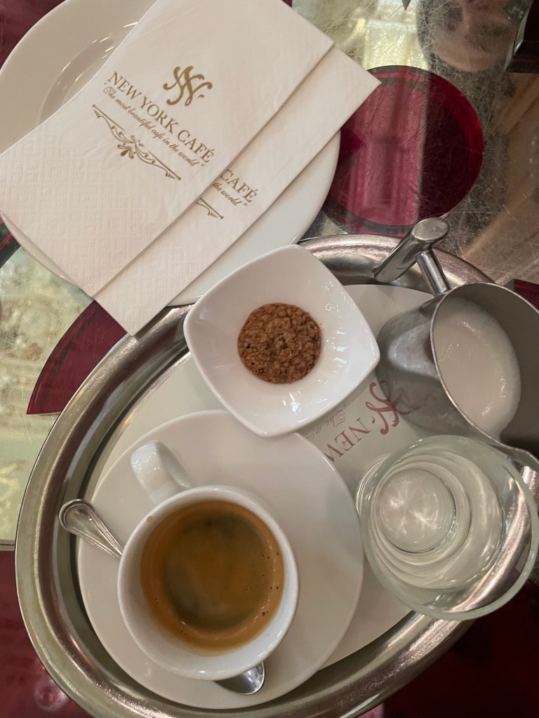 A view on a tray of coffee at the New York cafe in budapest, displaying napkins with its logo.