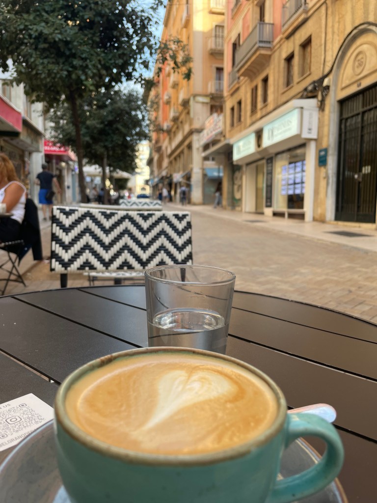 coffee on a table in a quiet street with beautiful morning sunlight.