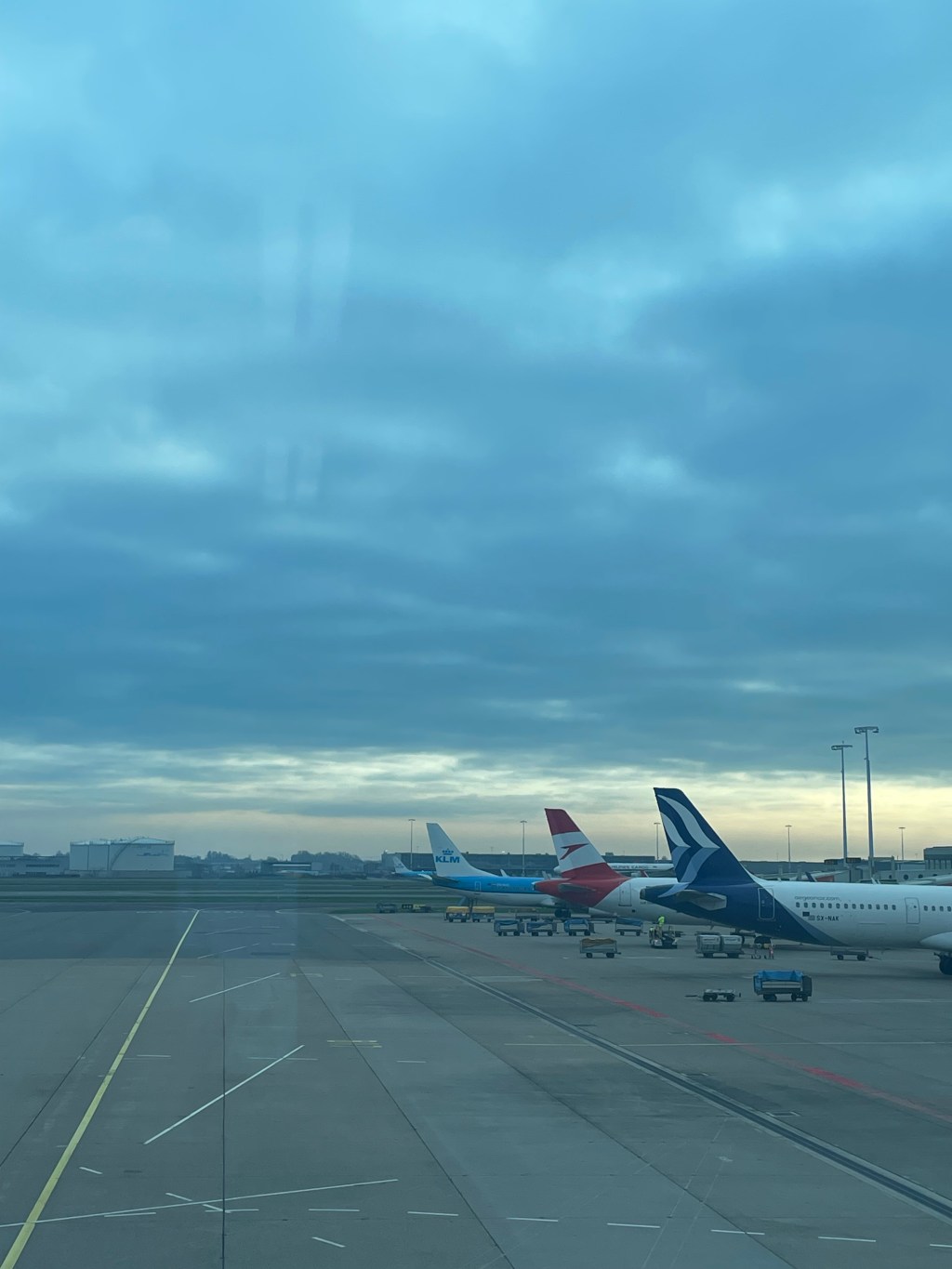 Planes parked at the airport with a gloomy morning sky.